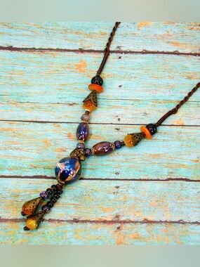 Multi color ceramic bead tassel necklace blue, green, brown tones on fabric cord